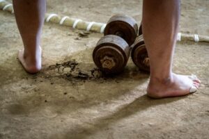 two bare legs with weights in between