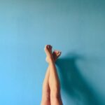 woman's knees on blue background