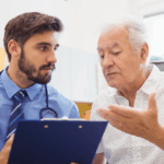 Older man speaking to doctor