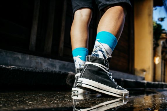 man in compression socks and converse sneakers